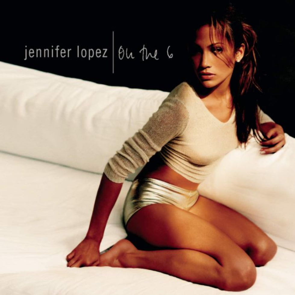Album cover featuring a person sitting on a bed with 'Jennifer Lopez On The 6' text.